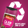 A promotional graphic features a large white recycling symbol behind a bottle of Schwartz Cajun Seasoning 44G to highlight that the jar and cap are recyclable.