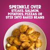 A plate of golden roasted potatoes seasoned with Schwartz Cajun Seasoning 44G is shown below text suggesting to sprinkle it over steaks, salmon, potatoes, pizzas, or stir it into baked beans.