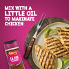 A bottle of Schwartz Cajun Seasoning 44G is shown next to a plate of grilled chicken breasts and lime wedges with text suggesting to mix the spice with oil for a marinade.