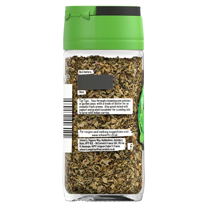 A clear glass Schwartz Mint 9G Jar filled with dried mint leaves features a green flip-top lid and a label with serving suggestions and contact information.