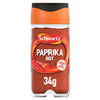 A clear glass jar of Schwartz Paprika Hot, 34G features a vibrant red ground spice and an orange cap with a black top.