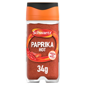 A clear glass jar of Schwartz Paprika Hot, 34G features a vibrant red ground spice and an orange cap with a black top.