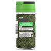 A clear glass jar of Schwartz Chives, 1G shows the dried green herbs through the bottle and features a label with serving suggestions and brand contact information.