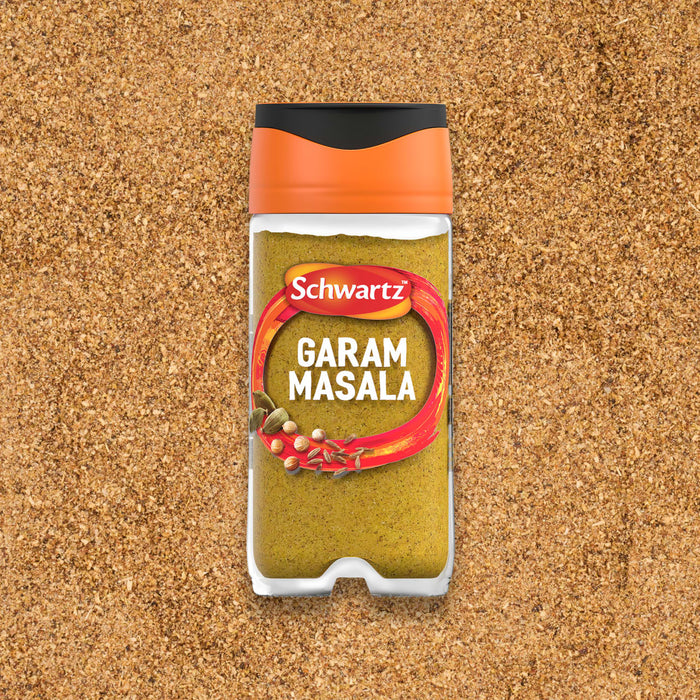 A clear jar of Schwartz Garam Masala, 30G, is shown from above, resting on a bed of the same ground spice blend.