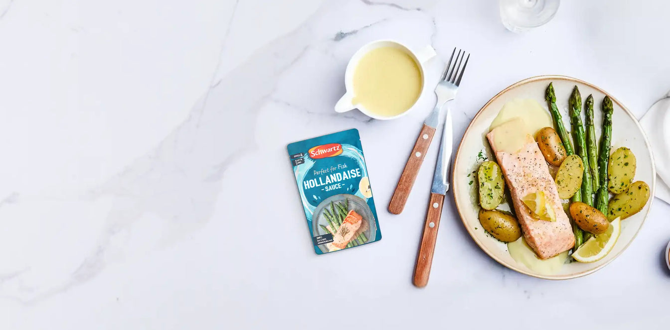 Schwartz Hollandaise Sauce packet beside a plate of salmon, potatoes, and asparagus