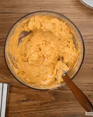 Glass bowl with buffalo dip on a wooden surface
