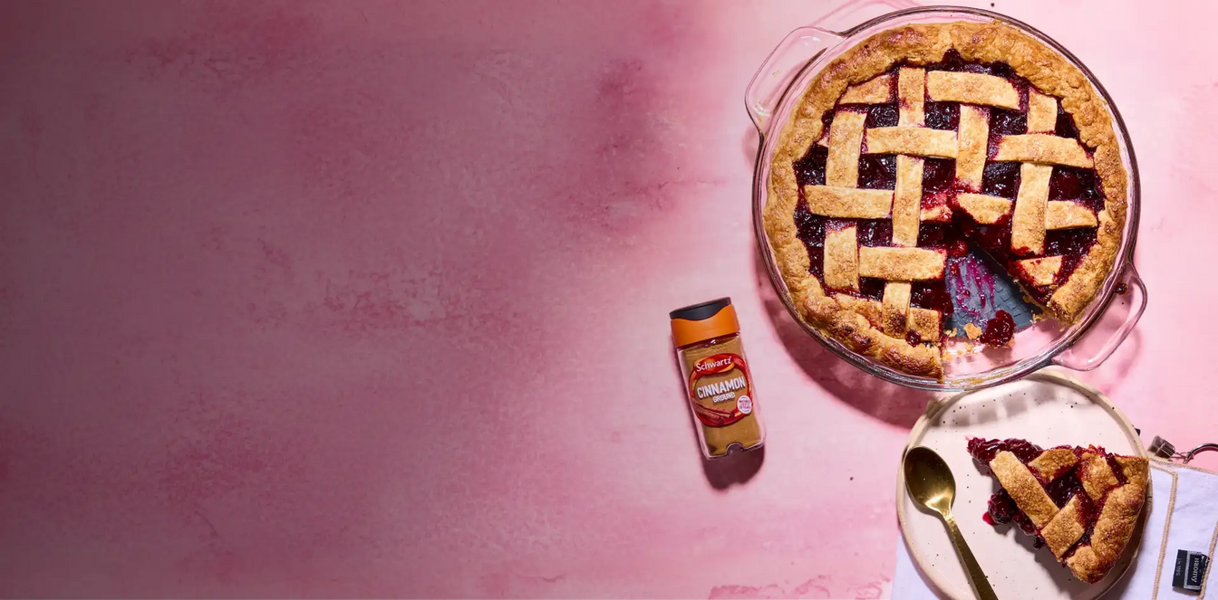 Blueberry pie with lattice crust on a pink background