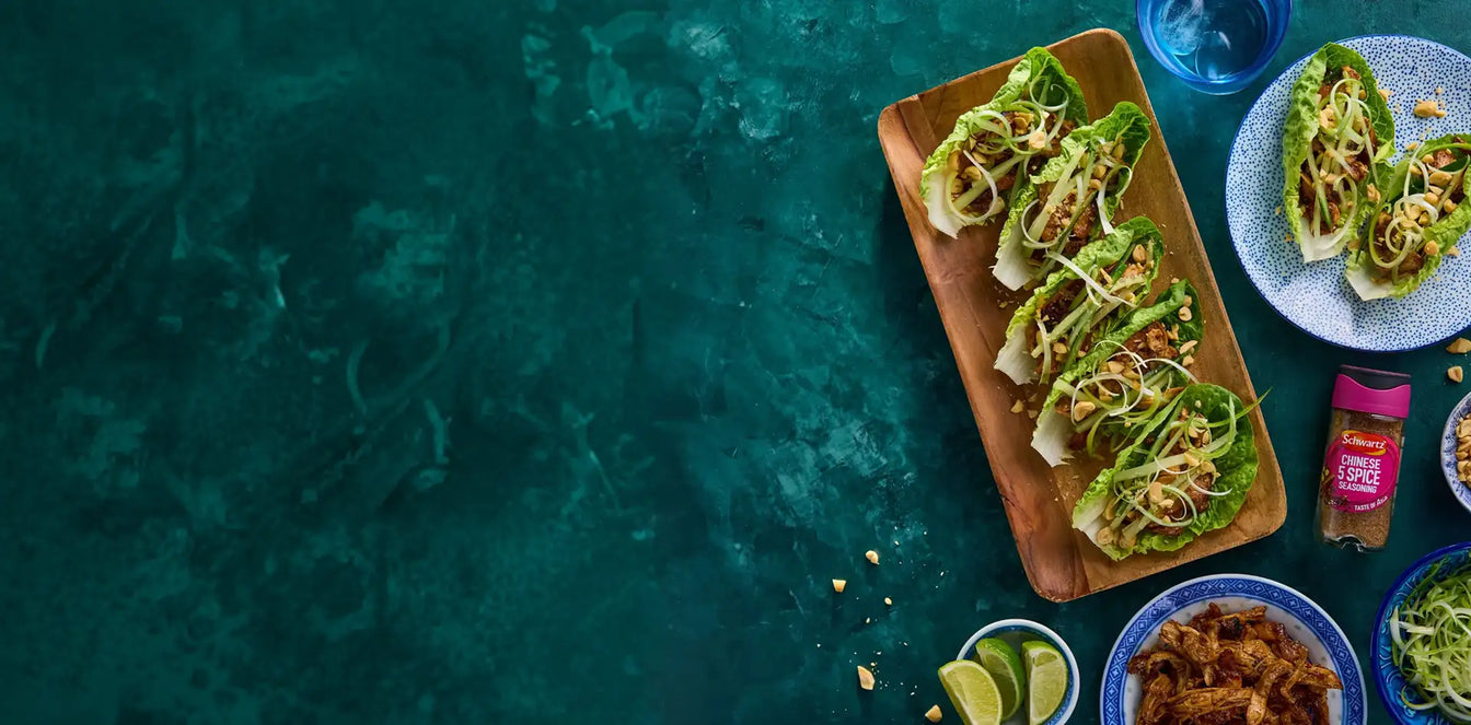 Lettuce wraps on a wooden plate with a blue background