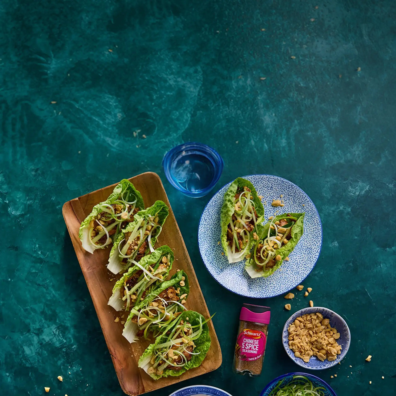 Lettuce wraps on a wooden plate with a blue background