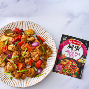air fryer product next to plate of food