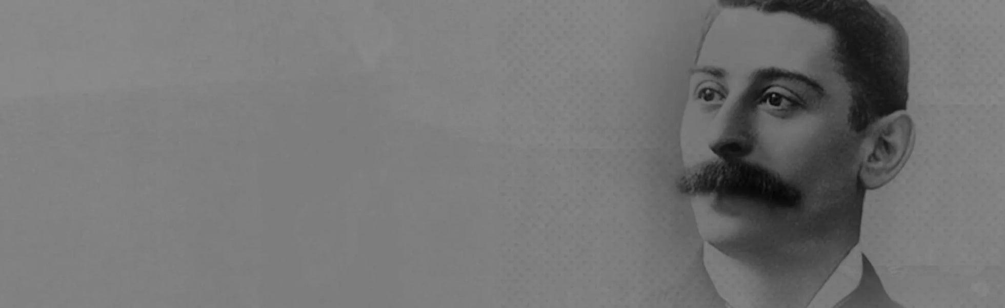 Black and white portrait of a man with a mustache against a textured gray background